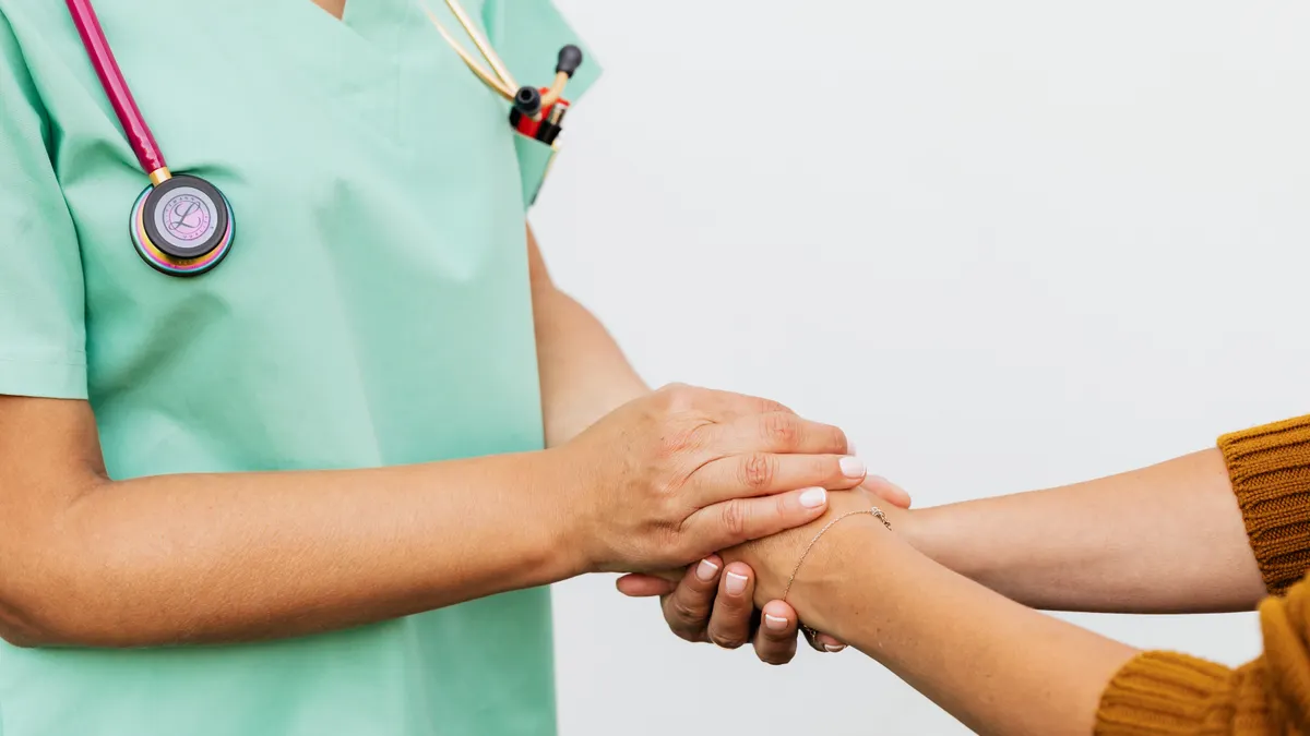 Nurse and patient shaking hands warmly at a new clinic, representing trust-based patient acquisition